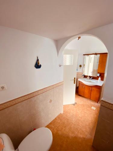 a bathroom with a toilet and a sink at Loutra Hills in Loutra