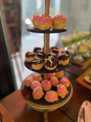 a three tiered display of donuts and pastries at Anantara Vacation Club Mai Khao Phuket in Mai Khao Beach