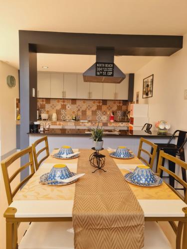 a dining room with a table and a kitchen at Bayview Country Inn El Nido in El Nido