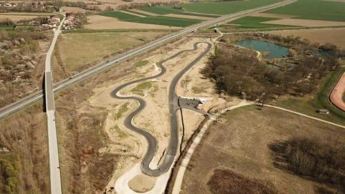 an aerial view of a road with a wind turbine at APARTMA LINDAU in Lendava