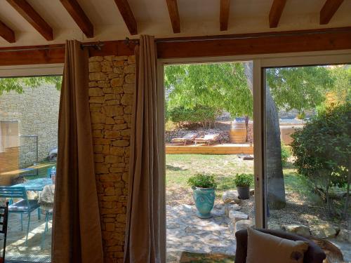 a sliding glass door with a view of a patio at La chambre haute, son jardin, et, son SPA in Nîmes