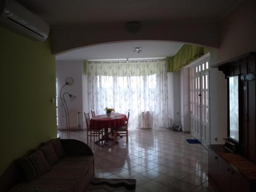 a living room with a table and a couch at Manor Villa in Hévíz