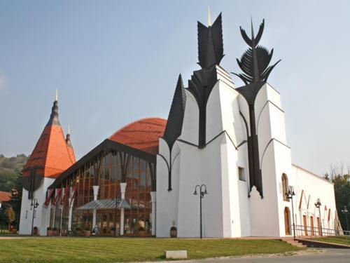 a large white church with a large building at APARTMA LINDAU in Lendava