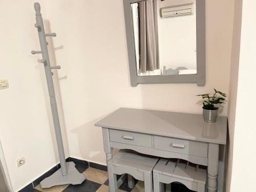 a bathroom with a white vanity and a mirror at Koala Place in Vasiliki
