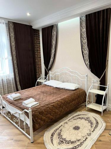 a bedroom with a large bed with a white frame at Lavender Night Apartments in Chernivtsi