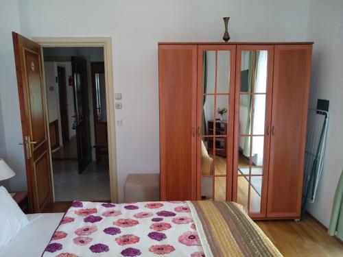 a bedroom with a bed and a wooden cabinet at Manor Villa in Hévíz
