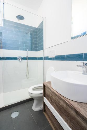 a bathroom with a white sink and a toilet at Hotel & Spa Relais Freedom Club in Massa Lubrense