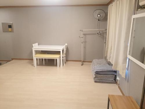 a room with a table and a table and a chair at Seorak HOT Spring Mammoth Resotel in Sokcho