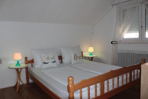 a bed in a bedroom with two lamps on tables at Kroatien Villa Merćepi in Katuni