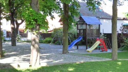 a playground with a slide and a swing set at Hotel Svornost in Prague