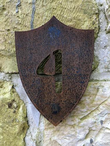 a metal shield on a stone wall at Chateau du Roi in Mi‘ilyā