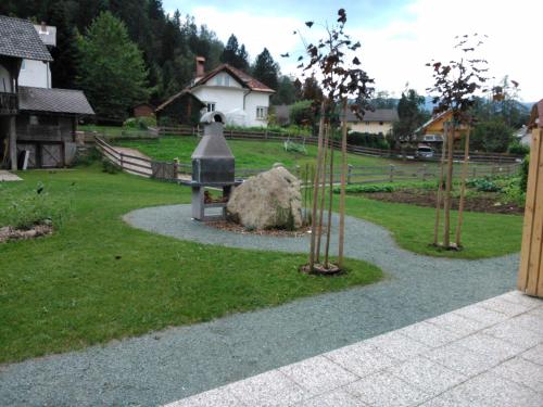 a garden with a statue in the middle of a yard at Viktoria Apartments in Bled