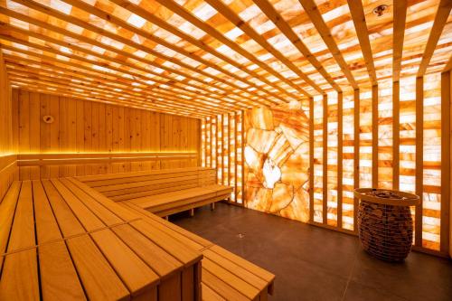 a wooden sauna with benches and a trash can at Emily Resort in Lviv