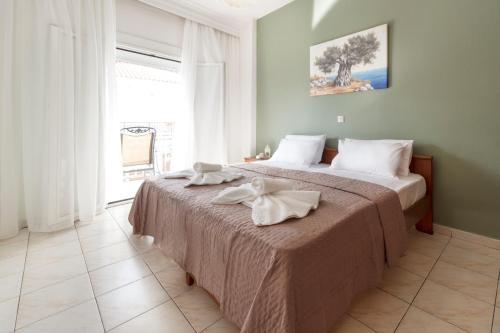 a bedroom with a bed with towels on it at Galini apartments Polyhrono in Kassandria