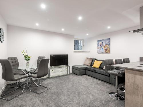 a living room with a couch and a table at Casa Fresa - Castle Heights Apartment in Dundee