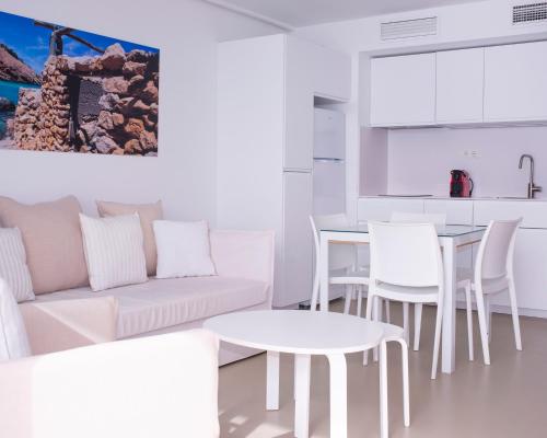 a living room filled with furniture and a table at Apartamentos Llobet Ibiza in Ibiza Town