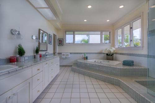 a bathroom with two sinks and a tub at Aloha 'Ohana home in Koloa