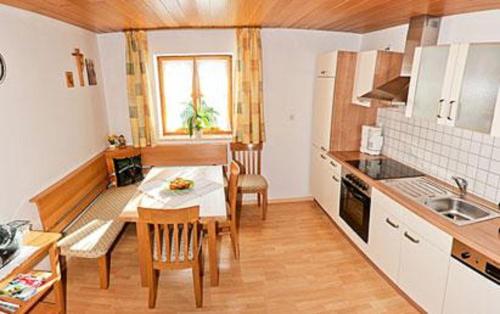 a kitchen with a table and a dining room at Ferienwohnungen Lusenblick in Freyung
