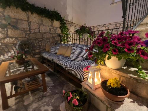 a living room with a couch and some flowers at Stone House Hedonia in Blato