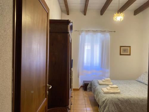 a small bedroom with two beds and a window at B&B Domenico Paulis in Tuili