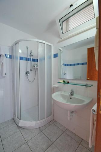a bathroom with a shower and a sink at HOTEL BALTIC in Alba Adriatica