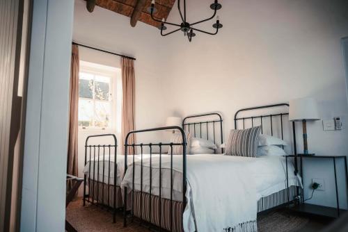a bedroom with two beds and a window at Penhill Farm Fruit Barn in Nuy