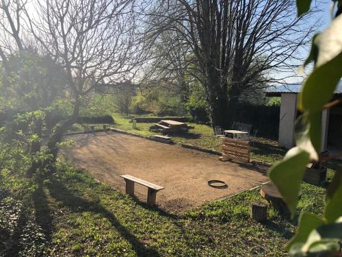 a park with two benches and a playground at Chambre d'hôtes LOU PATACLET in Charols