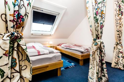 a room with two beds and a window at Relax Apartment Köln Merheim in Cologne
