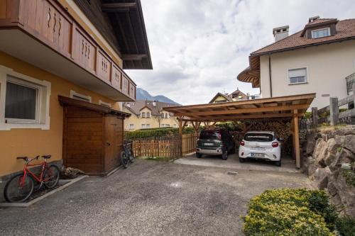 a garage with a car parked next to a house at Apartments Stua da Carlo in Ortisei