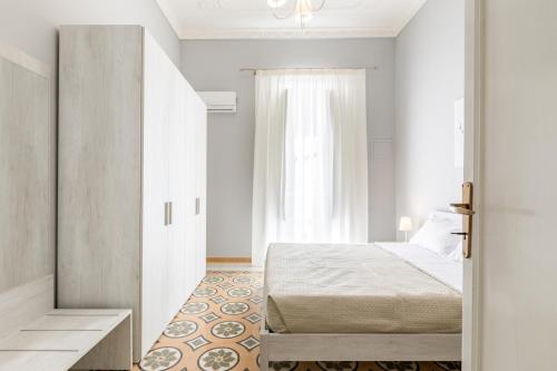 Posteľ alebo postele v izbe v ubytovaní Stazione Notarbartolo Bright & Cozy Apartment