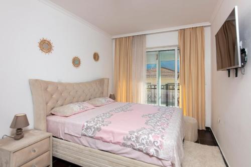a bedroom with a bed and a window at ENA Apartment in Kotor