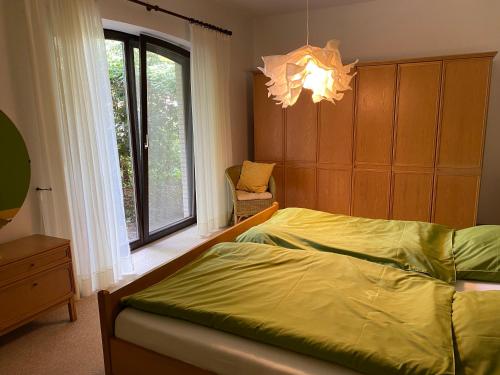 a bedroom with a bed and a window and a chandelier at Apartment Schomaker-Fatmann in Werlte