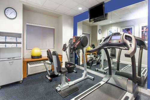 a gym with cardio equipment in a room at Microtel Inn & Suites by Wyndham Port Charlotte Punta Gorda in Port Charlotte