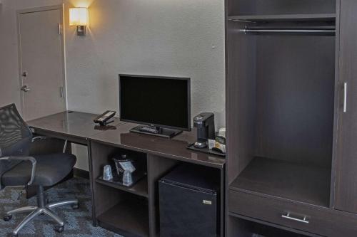 a desk with a computer on it in a hotel room at Sleep Inn Lake Wright - Norfolk Airport in Norfolk
