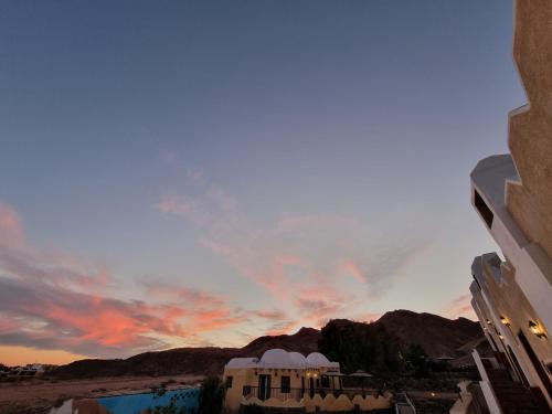 a view of the sunset from the balcony of a building at The Bedouin Moon in Dahab