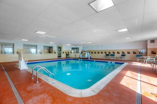 a swimming pool with a pool table and chairs in it at Quality Inn & Suites Wellington – Fort Collins in Wellington