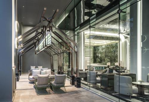 a lobby with chairs and tables in a building at Grande Centre Point Space Pattaya in Pattaya North