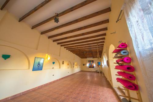 a hallway in a house with a ceiling with beams at The Bedouin Moon in Dahab