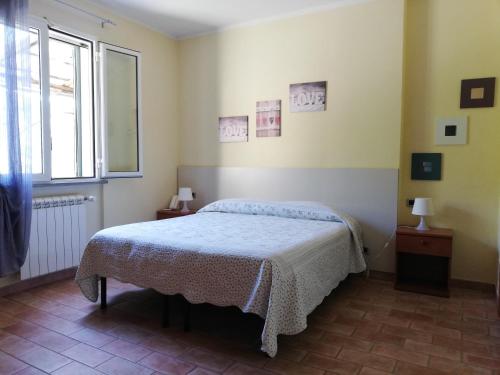 a bedroom with a bed and a window at Locanda Cà de Rusitta in Vezzi Portio