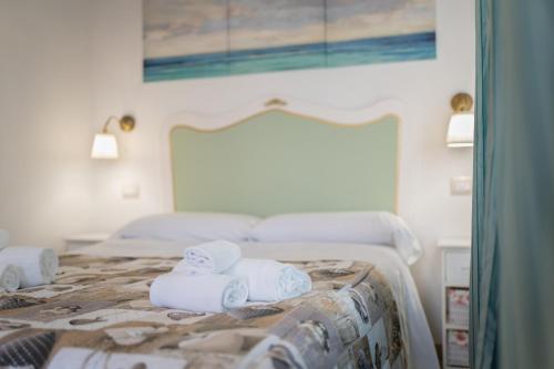 a bedroom with a bed with towels on it at RomAntica in Polignano a Mare