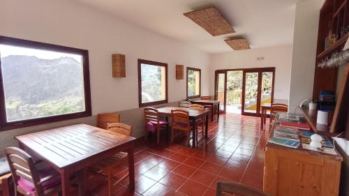 a dining room with tables and chairs and windows at Casa Cavoquinho in Paul