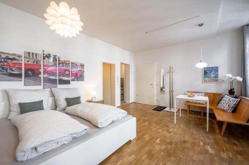 a white living room with a white couch and a desk at Große Altstadtwohnung in TOP Lage Zentrum in Dresden