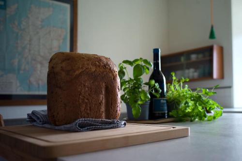 a cake sitting on a table with a bottle of wine at The Presbytery, Forres in Forres