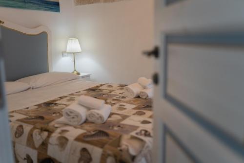 a bedroom with a bed with towels on it at RomAntica in Polignano a Mare