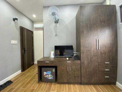 a room with a large wooden cabinet with a fan at CONVOI HOTEL in Can Tho
