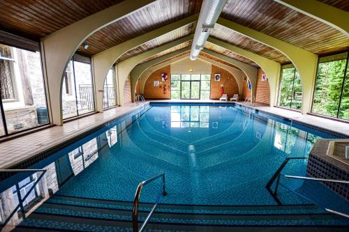 a large swimming pool with stairs in a building at The Pitlochry Hydro Hotel in Pitlochry