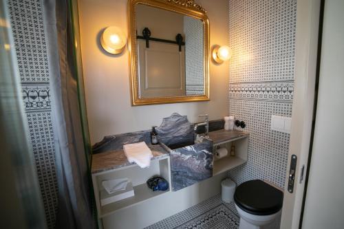 a bathroom with a sink and a mirror at Hotel Siglunes in Siglufjörður
