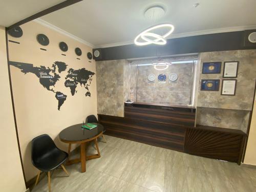 a room with a map of the world on the wall at Azimut in Balykchy