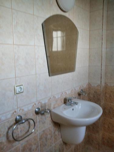 a bathroom with a sink and a mirror at Къща за гости Релакс-Рaдуил in Raduil