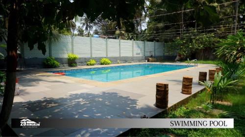 a swimming pool in the backyard of a house at Aroma boutique villa by 29 Bungalow in Nagaon